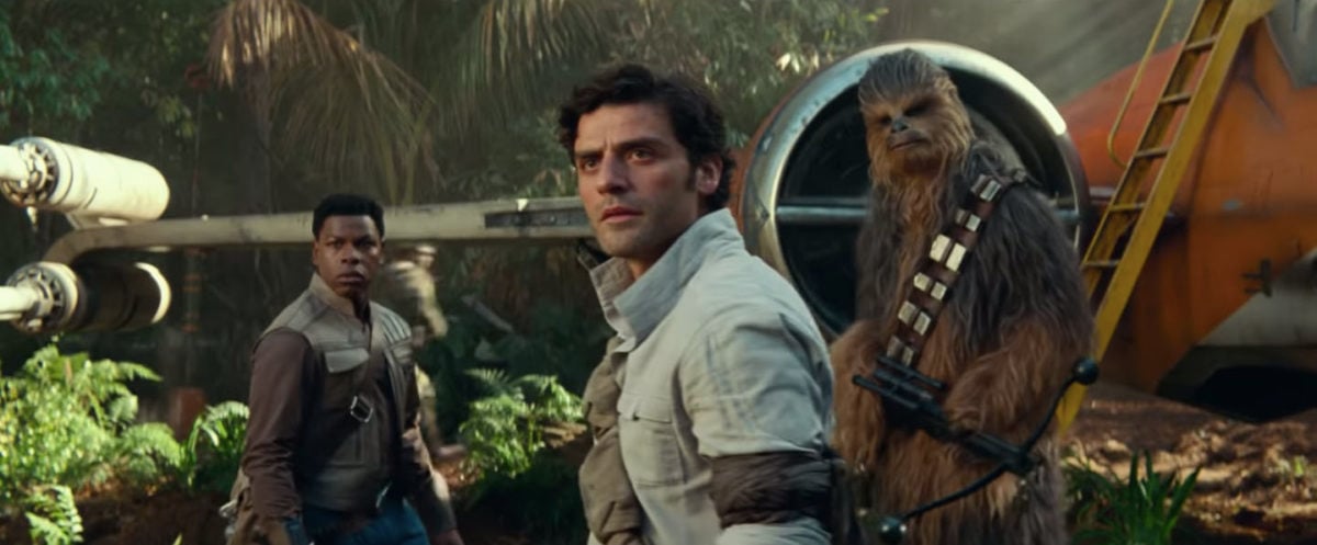 Poe Dameron, Finn, and Chewbacca standing outside a ship in a jungle in Star Wars: The Rise of Skywalker trailer.
