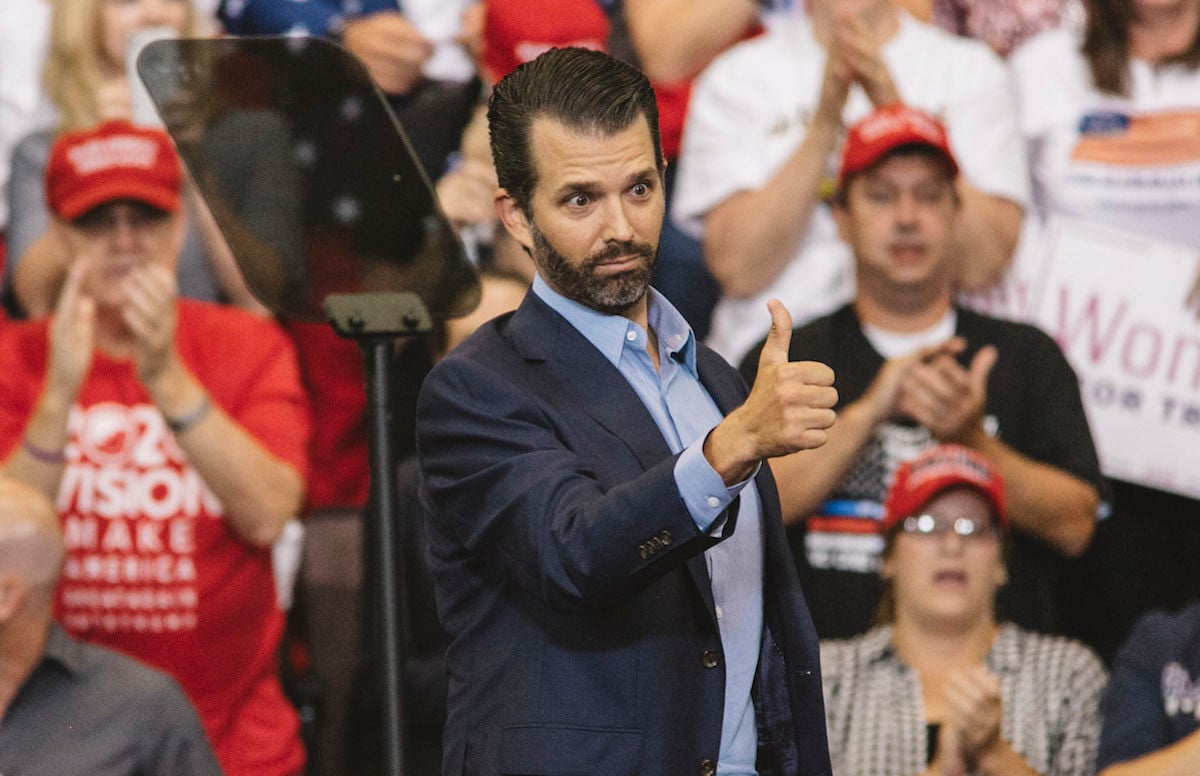 Donald Trump Jr. gives a thumbs up from the stage of his daddy's rally.