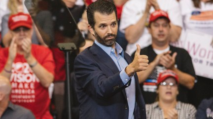Donald Trump Jr. gives a thumbs up from the stage of his daddy's rally.