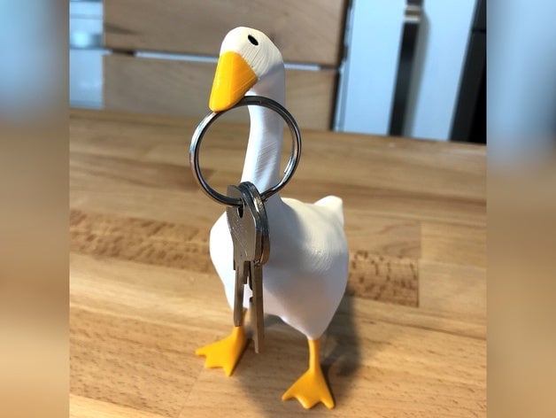 A 3d printed goose holds keys in its beak.