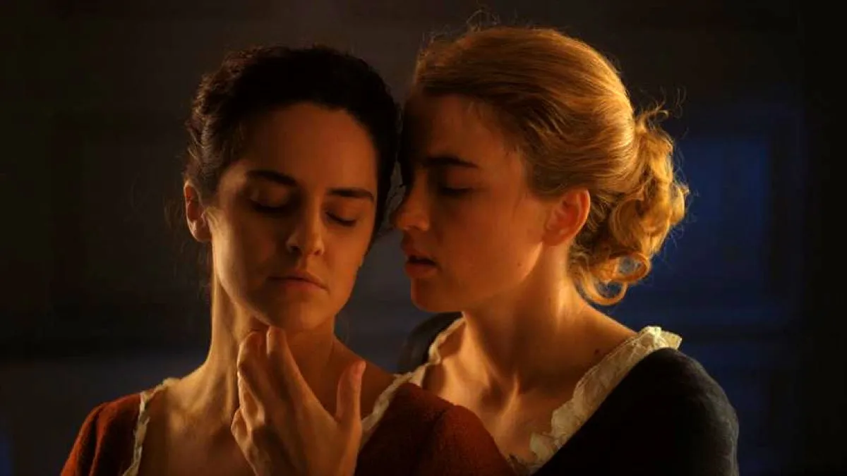 Marianne (Noémie Merlant) and Héloïse (Adèle Haenel), eyes closed, share a passionate embrace in "Portrait of a Lady on Fire"