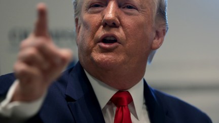 A close-up of Donald Trump pointing at something.