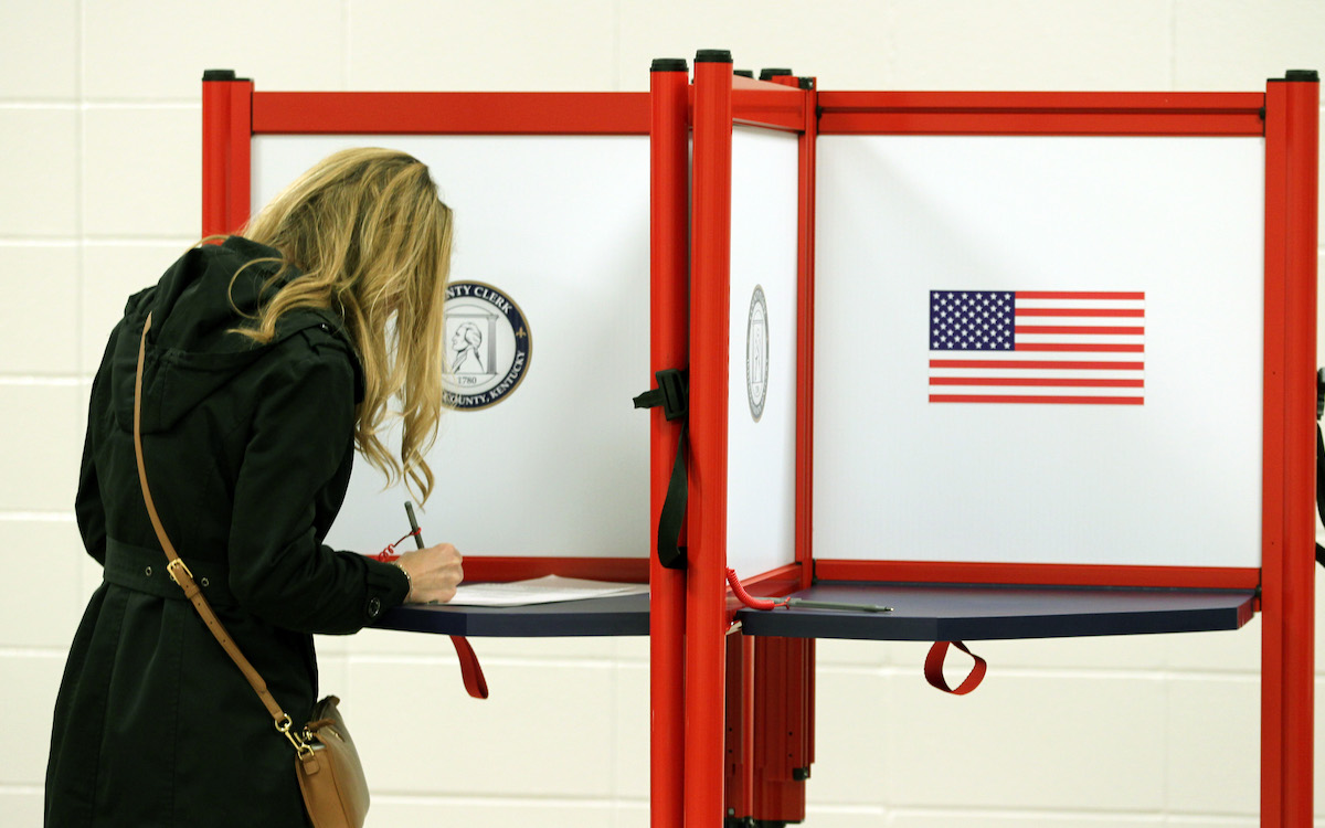 Female voter fills out a ballot on election day.