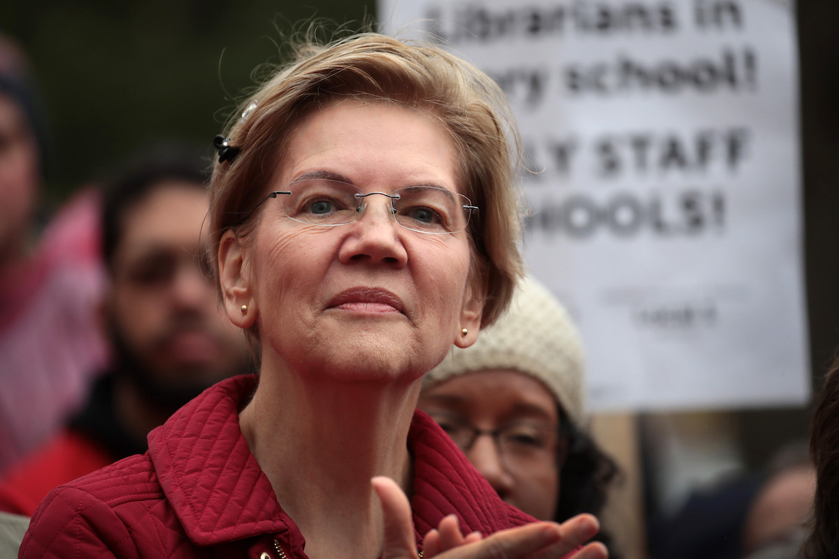 Elizabeth Warren clapping at a rally for striking teachers.