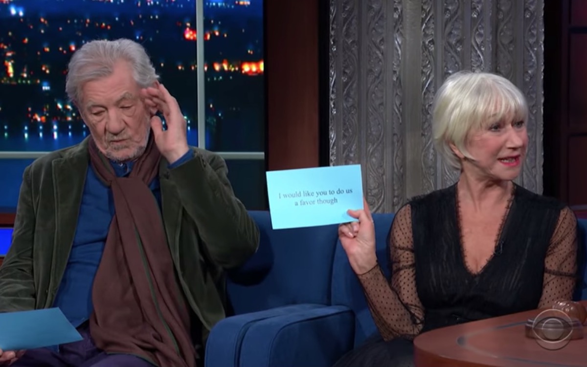 Helen Mirren and Ian McKellen read from cards on the Late Show stage.
