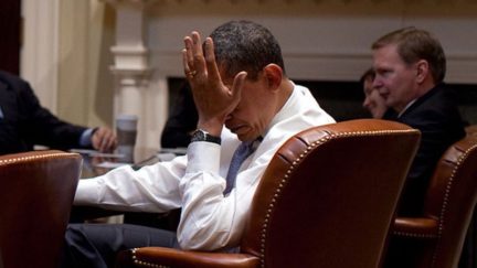 Barack Obama does a facepalm.