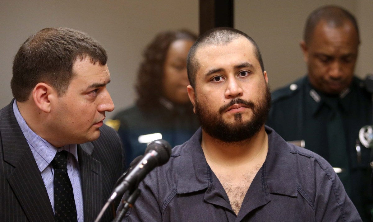 SANFORD, FL - NOVEMBER 19: George Zimmerman, the acquitted shooter in the death of Trayvon Martin, listens to defense counsel Daniel Megaro (L) during a first-appearance hearing on charges including aggravated assault stemming from a fight with his girlfriend November 19, 2013 in Sanford, Florida. Zimmerman, 30, was arrested after police responded to a domestic disturbance call at a house. He was acquitted in July of all charges in the shooting death of unarmed, black teenager, Trayvon Martin. (Photo by Joe Burbank-Pool/Getty Images)