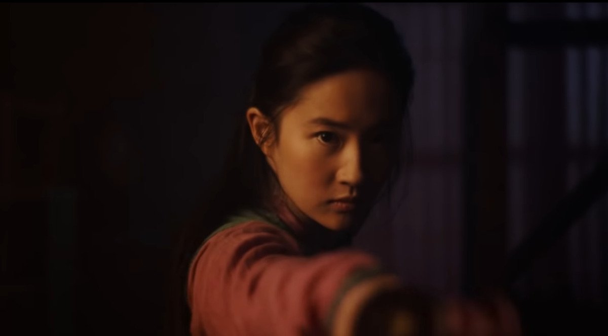 Yifei Liu as Mulan holding her ftaher's sword