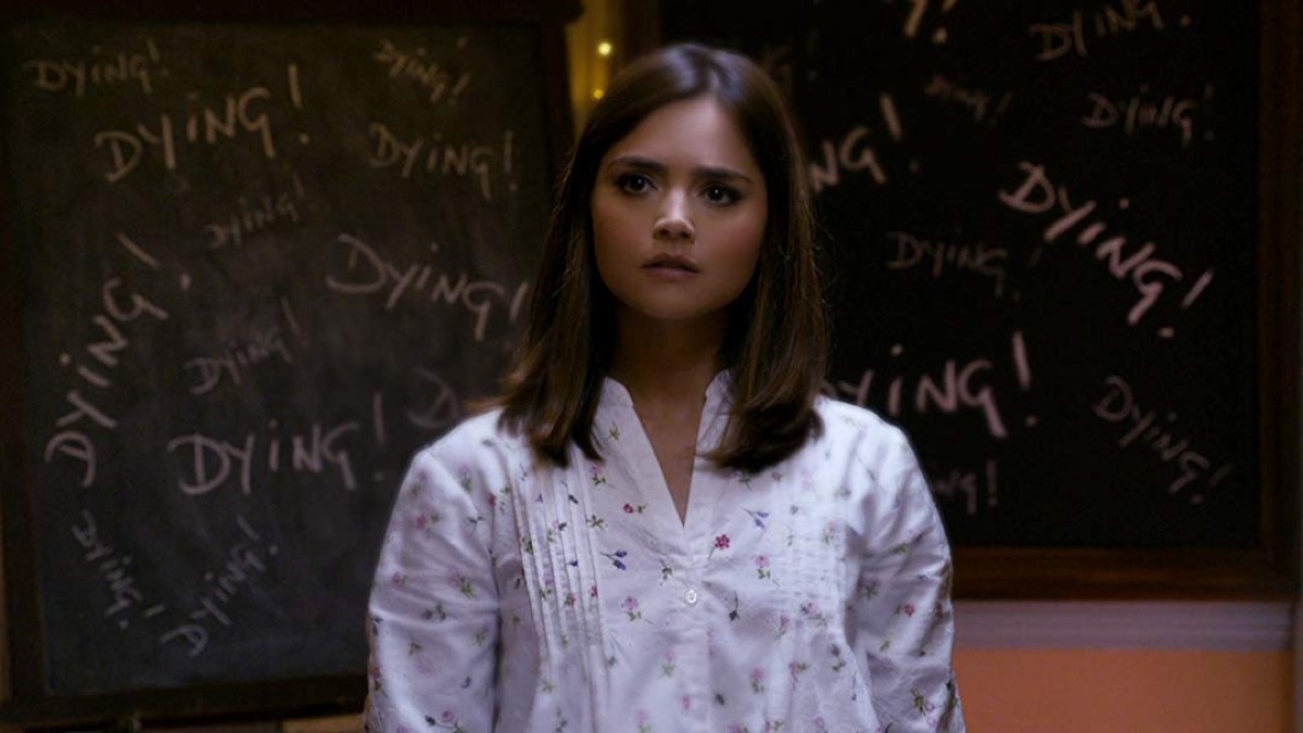 Clara in front of the word "dying" written a bunch of times on blackboards in BBC's Doctor Who.