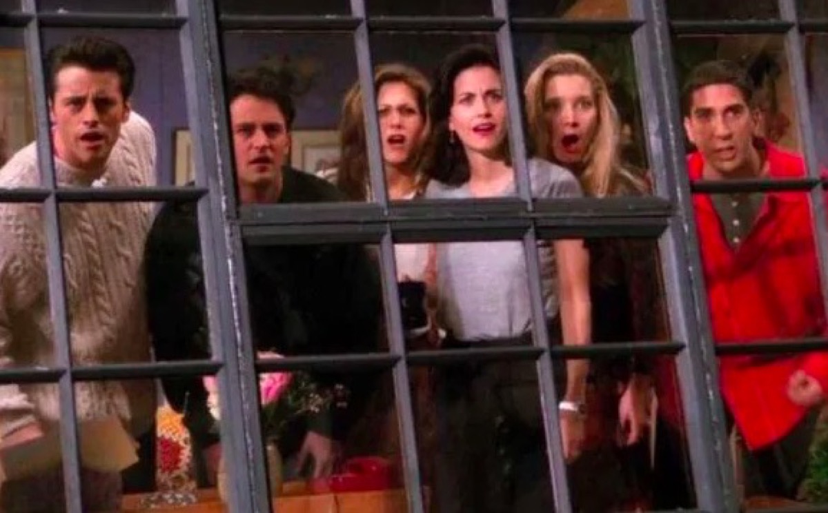 The cast of the show Friends looking out their apartment window.