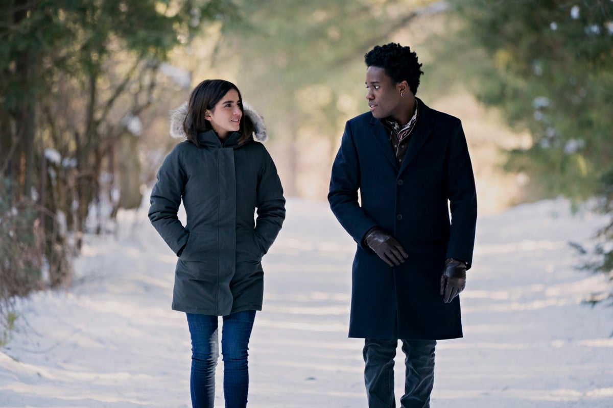Isabela Merced, Shameik Moore walk together through the snow in Netflix's Let It Snow.