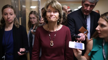 Sen. Lisa Murkowski (R-AK) (C) talks with reporters as she heads for the weekly Senate Republican policy luncheon