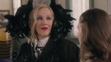 moira rose in a hat or wig made of black feathers