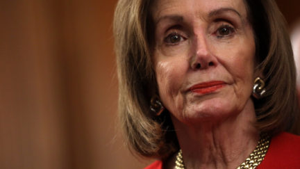 Rep. Nancy Pelosi (D-CA) listens during an event