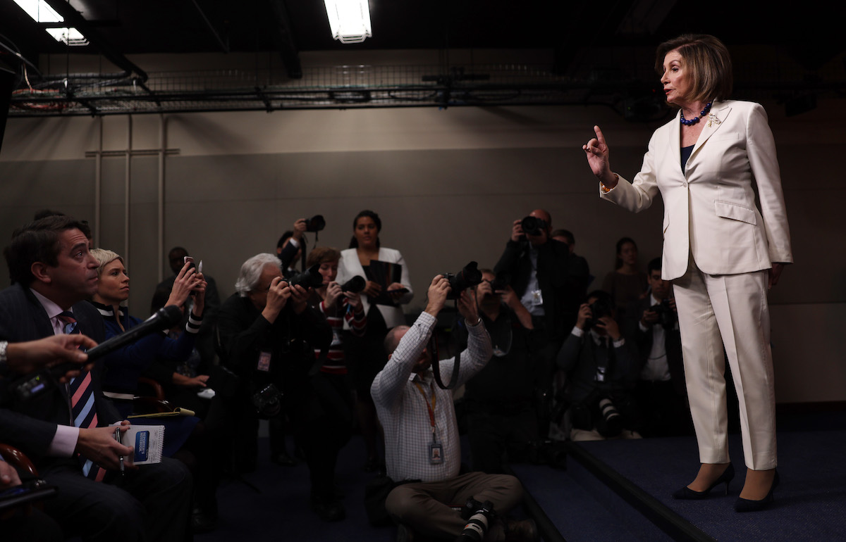 U.S. Speaker of the House Rep. Nancy Pelosi (D-CA) reacts to a reporter’s (L) question about whether she hates President Donald Trump during her weekly news conference