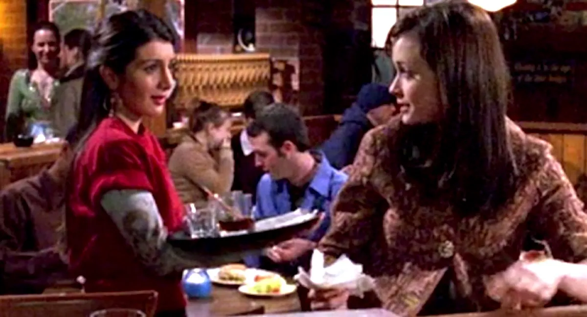 Nasim Pedrad as a waitress, talking to Rory at a bar in Gilmore Girls.