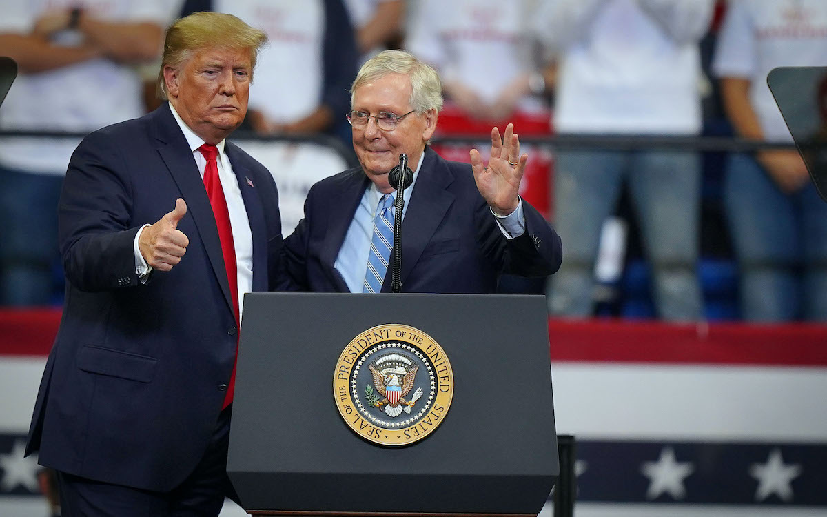 Donald Trump stands with Senate Majority Leader Mitch McConnell during a campaign rally