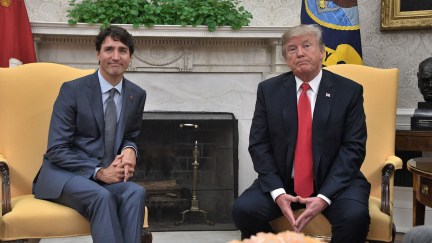 Donald Trump and Justin Trudeau sit and smile awkwardly in the White House.