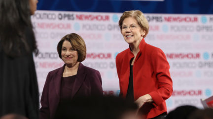 Democratic presidential candidate Sen. Elizabeth Warren (D-MA) (R) and Sen. Amy Klobuchar (D-MN)) walk on the stage after the Democratic presidential primary debate