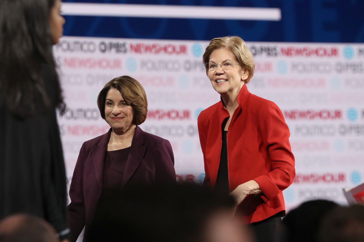 Democratic presidential candidate Sen. Elizabeth Warren (D-MA) (R) and Sen. Amy Klobuchar (D-MN)) walk on the stage after the Democratic presidential primary debate