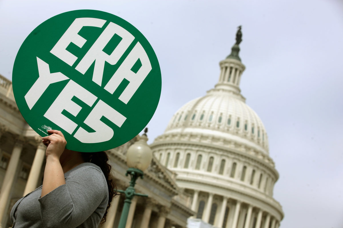 WASHINGTON, DC - MARCH 22: A woman hold up a sign as members of Congress and representatives of women's groups hold a rally to mark the 40th anniversary of congressional passage of the Equal Rights Amendment (ERA) outside the U.S. Capitol March 22, 2012 in Washington, DC. Rep. Carolyn Maloney (D-NY) and Sen. Robert Menendez (D-NJ) introduced a new version of the Equal Rights Amendment last year and called for it to be passed again. (Photo by Chip Somodevilla/Getty Images)