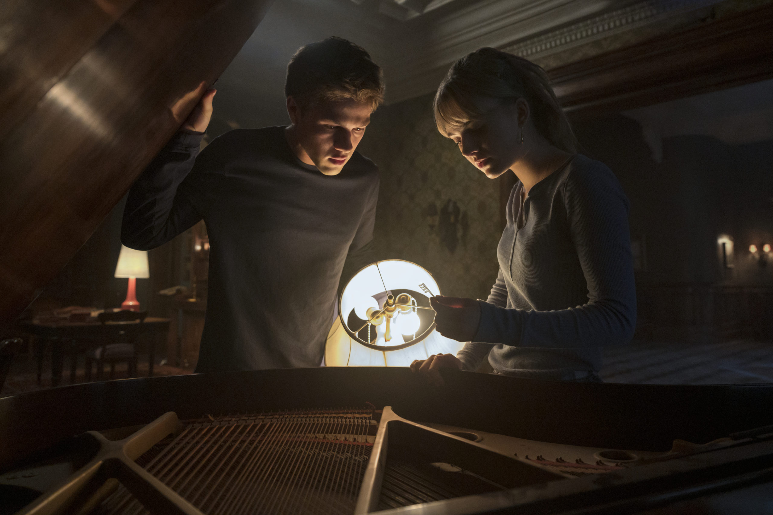 two siblings look at a glowing key