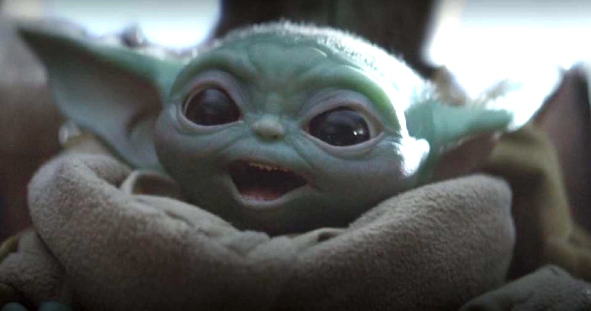 Baby Yoda with a wide-mouth smile in Disney+'s The Mandalorian Star Wars series.