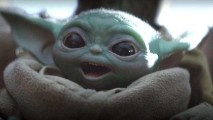 Baby Yoda with a wide-mouth smile in Disney+'s The Mandalorian Star Wars series.