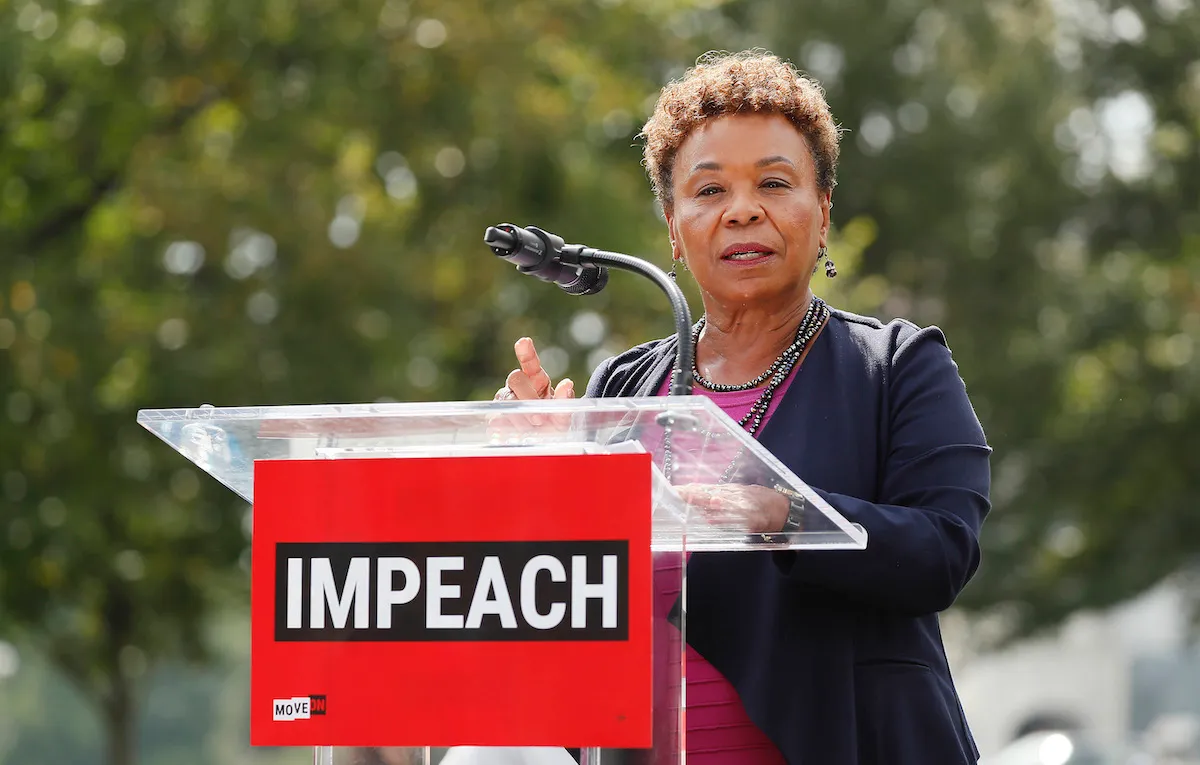 Rep. Barbara Lee (D-CA) speaks from a podium at the Impeachment Now! rally
