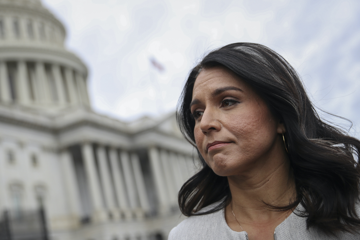 Tulsi Gabbard looks super sad with the US Capitol Building in the background.