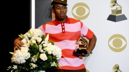 Tyler the Creator poses in the press room with the award for Best Rap Album for 
