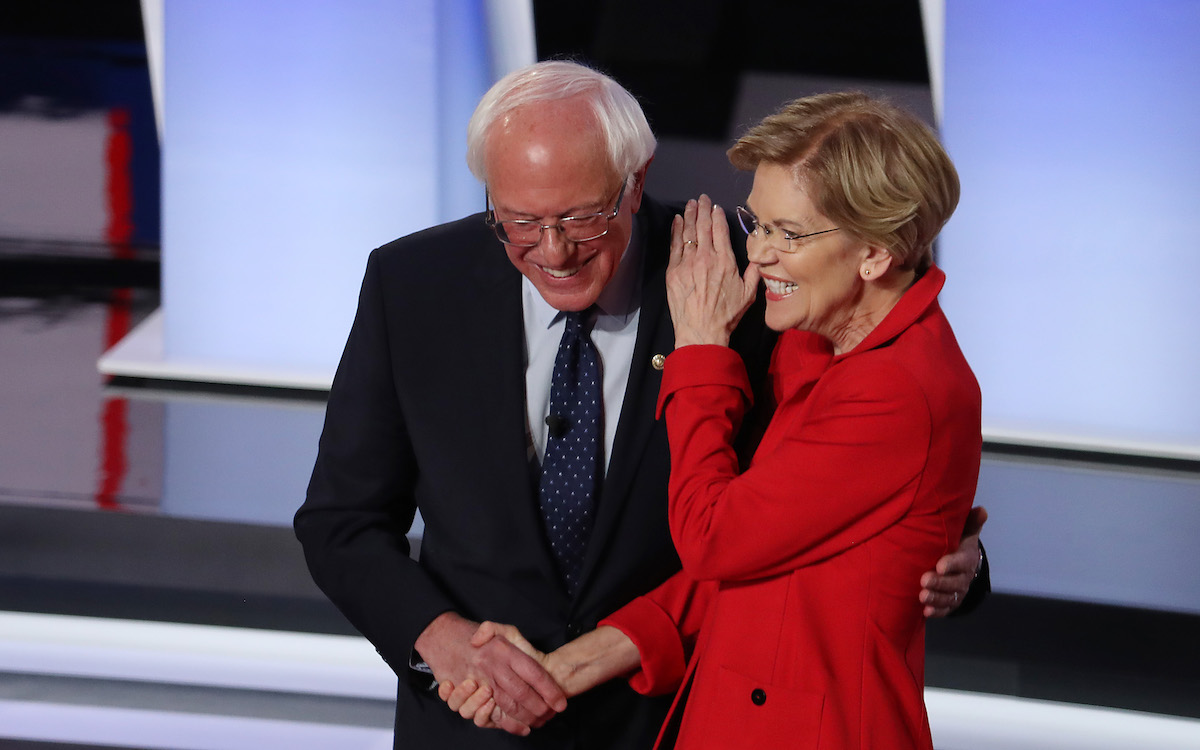Democratic presidential candidate Sen. Bernie Sanders (I-VT) (R) and Sen. Elizabeth Warren (D-MA) hug and greet each other at the start of the Democratic Presidential Debate