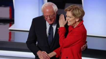 Democratic presidential candidate Sen. Bernie Sanders (I-VT) (R) and Sen. Elizabeth Warren (D-MA) hug and greet each other at the start of the Democratic Presidential Debate