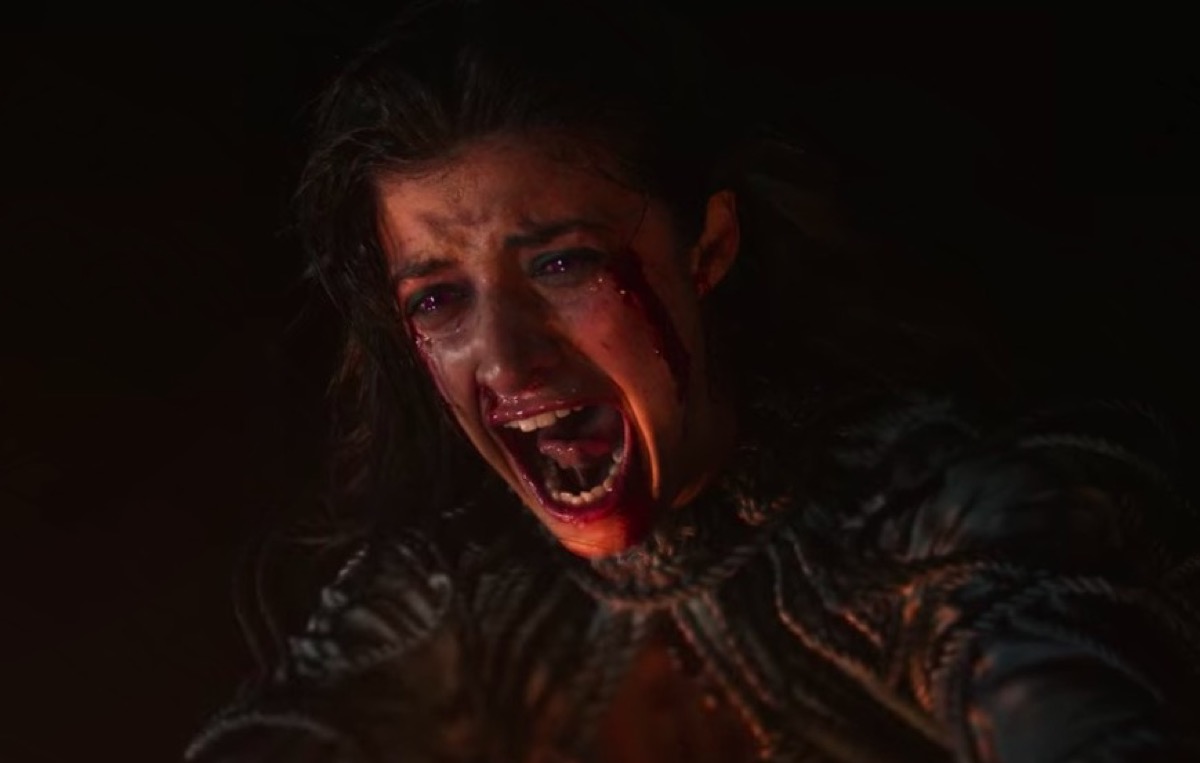 Yennefer, face bloody, screams as she shoots flames from her hands in Netflix's The Witcher.