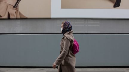 MILAN, ITALY - FEBRUARY 25: A woman, wearing a respiratory mask, walks in the streets on February 25, 2020 in Milan, Italy. Italy is the last country to be hit hard by the virus with 7 dead and more than 283 infected as of today. The spread marks Europe’s biggest outbreak, prompting the Italian Government to issue draconian safety measures. (Photo by Emanuele Cremaschi/Getty Images)