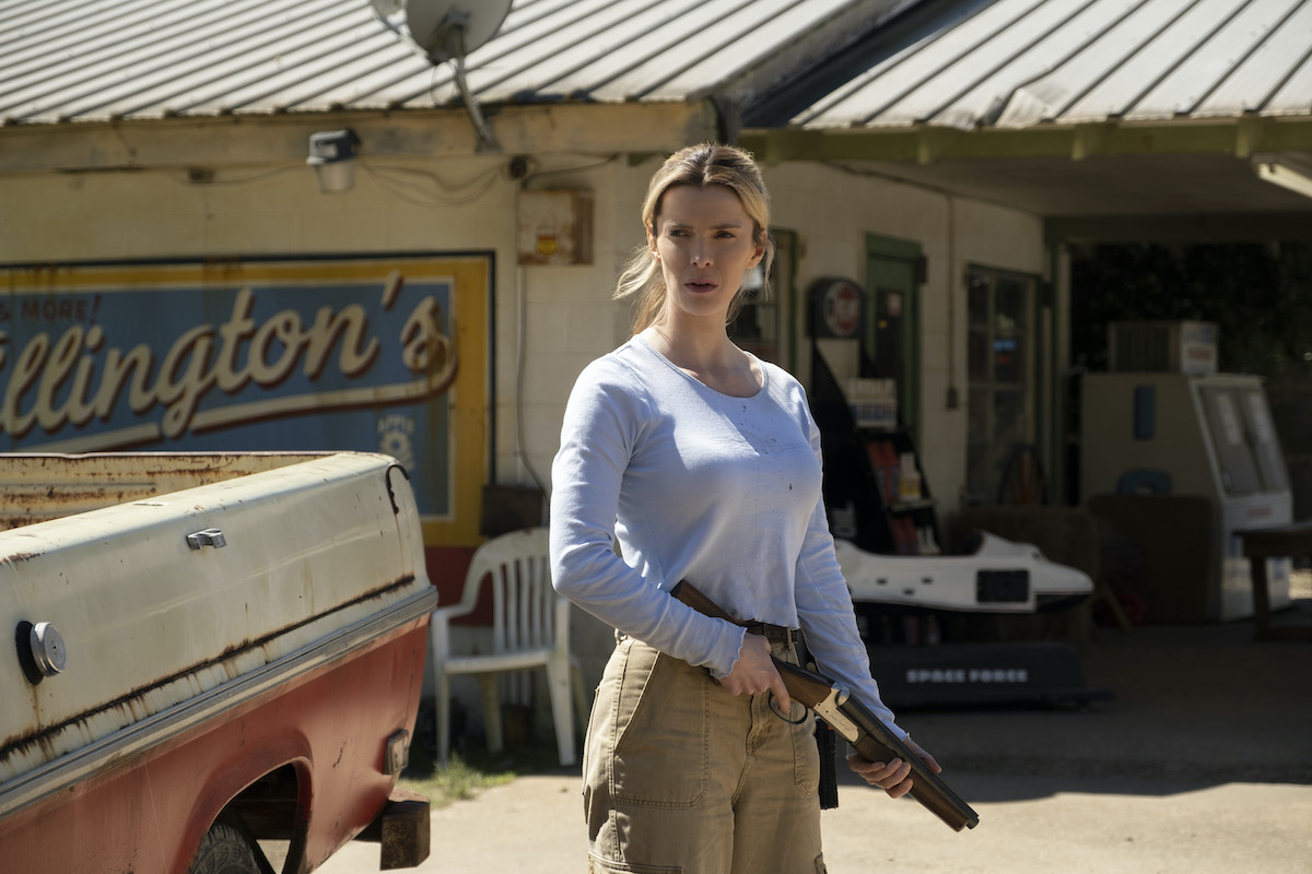 Betty Gilpin holds a shotgun in a still from The Hunt.