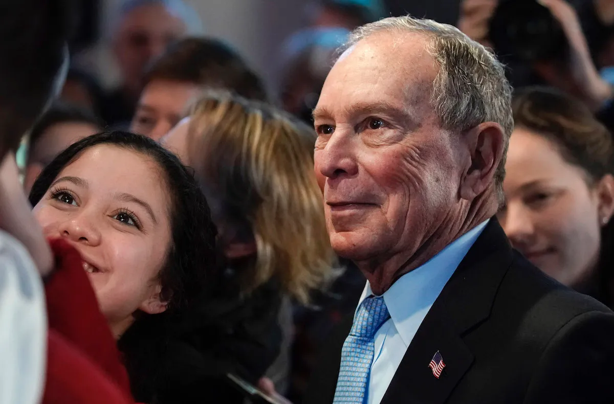 Mike Bloomberg takes a selfie after speaking to supporters at a rally