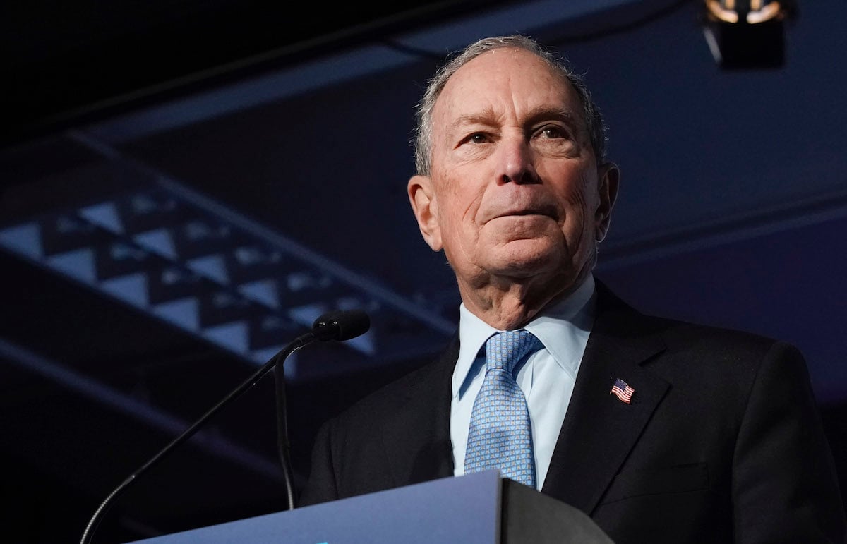 Mike Bloomberg stands at a podium.