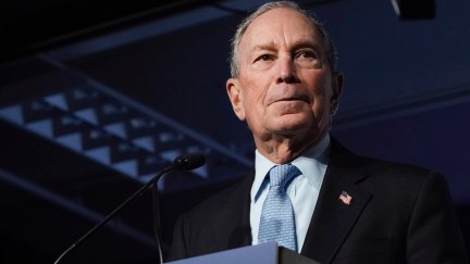 Mike Bloomberg stands at a podium.