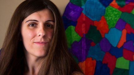 Danica Roem poses in from of a colorful mosaic