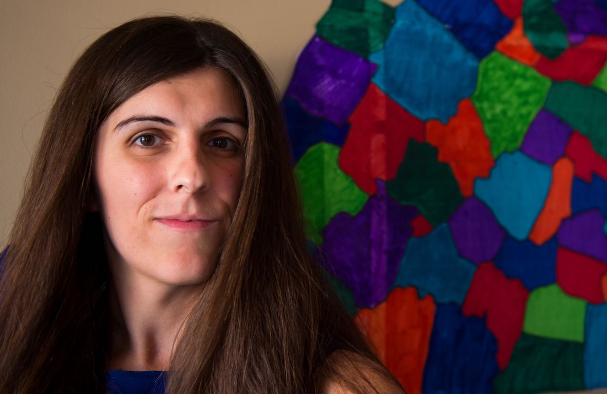 Danica Roem poses in from of a colorful mosaic