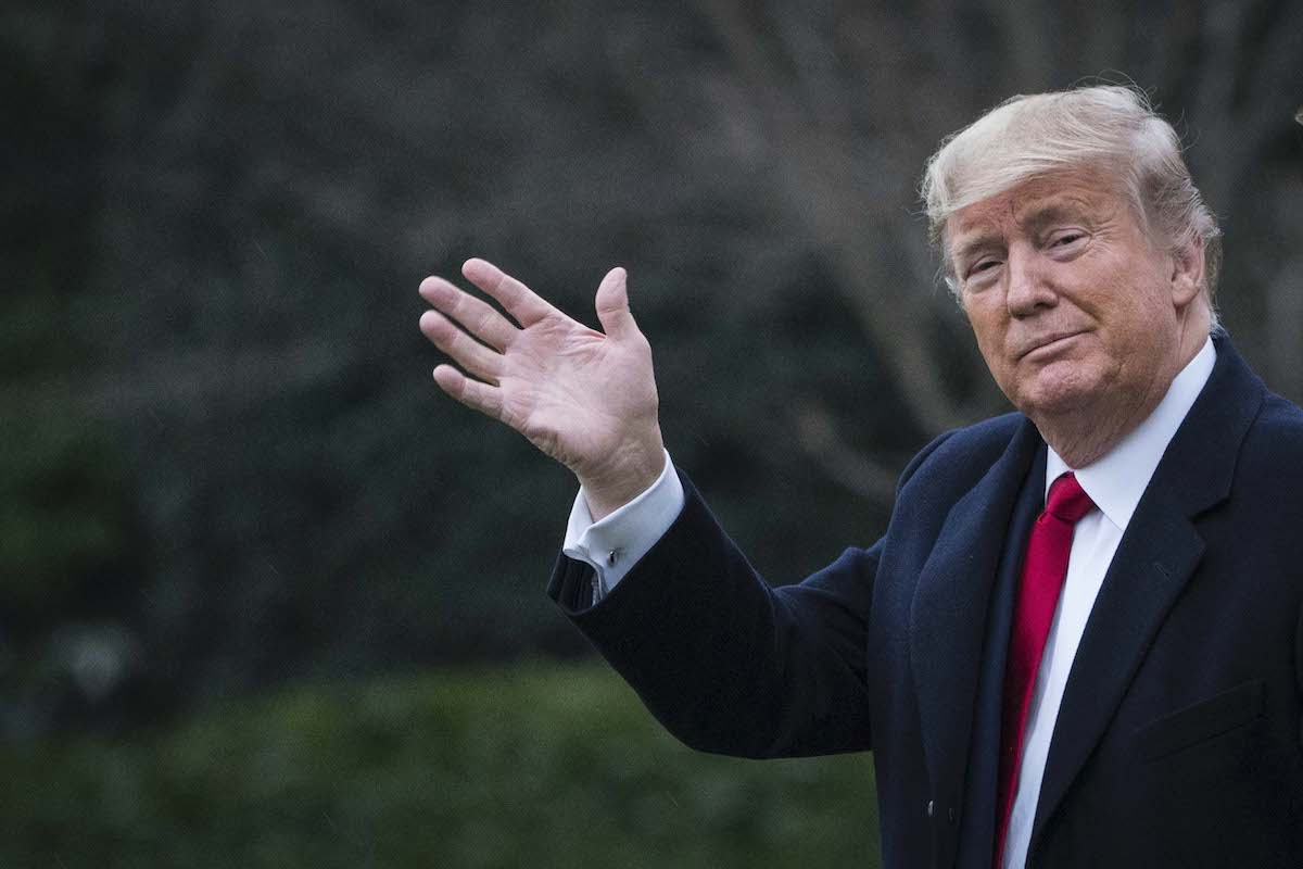 Donald Trump gives a stupid wave.