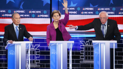 Democratic presidential candidate Sen. Bernie Sanders (I-VT) (R) gestures as Sen. Elizabeth Warren (D-MA) raises her hand and former New York City mayor Mike Bloomberg listen during the Democratic presidential primary debate