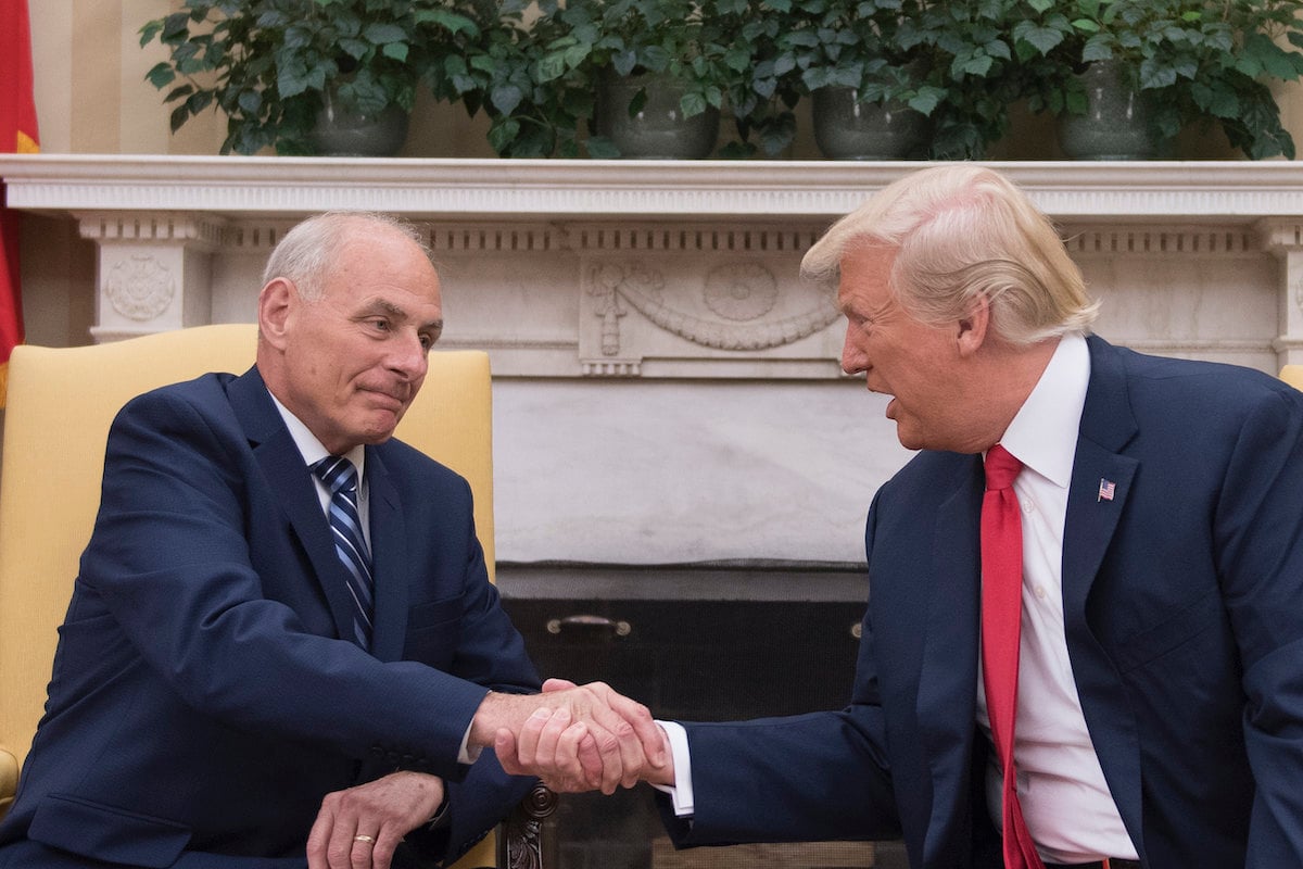 Donald Trump (R) shakes hands with newly sworn-in White House Chief of Staff John Kelly at the White House