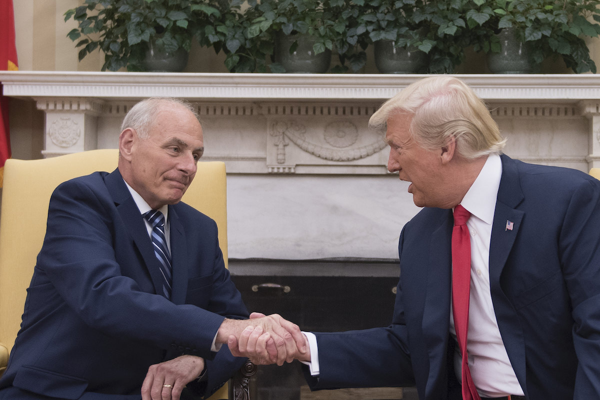 Donald Trump (R) shakes hands with newly sworn-in White House Chief of Staff John Kelly at the White House