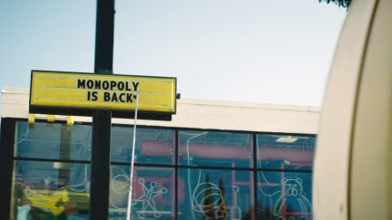 Monopoly is back sign in front of a mcdonalds