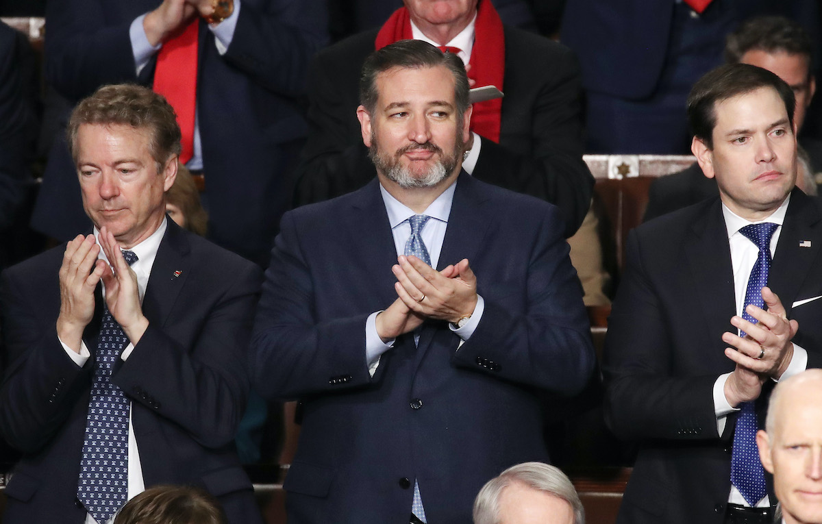 Senators Rand Paul (R-KY), Ted Cruz (R-TX) and Marco Rubio (R-FL) applaud during the State of the Union address