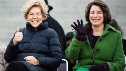 Democratic presidential candidates, Sen. Elizabeth Warren (D-MA), left, and Sen. Amy Klobuchar (D-MN) gesture to the crowd during the King Day at the Dome rally