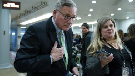 WASHINGTON, DC - JANUARY 23: Sen. Richard Burr (R-NC) speaks with a reporter as he walks through the Senate subway before the impeachment trial of President Donald Trump resumes at the U.S. Capitol on January 23, 2020 in Washington, DC. Democratic House managers will continue their opening arguments on Thursday as the Senate impeachment trial of President Donald Trump continues. (Photo by Drew Angerer/Getty Images)