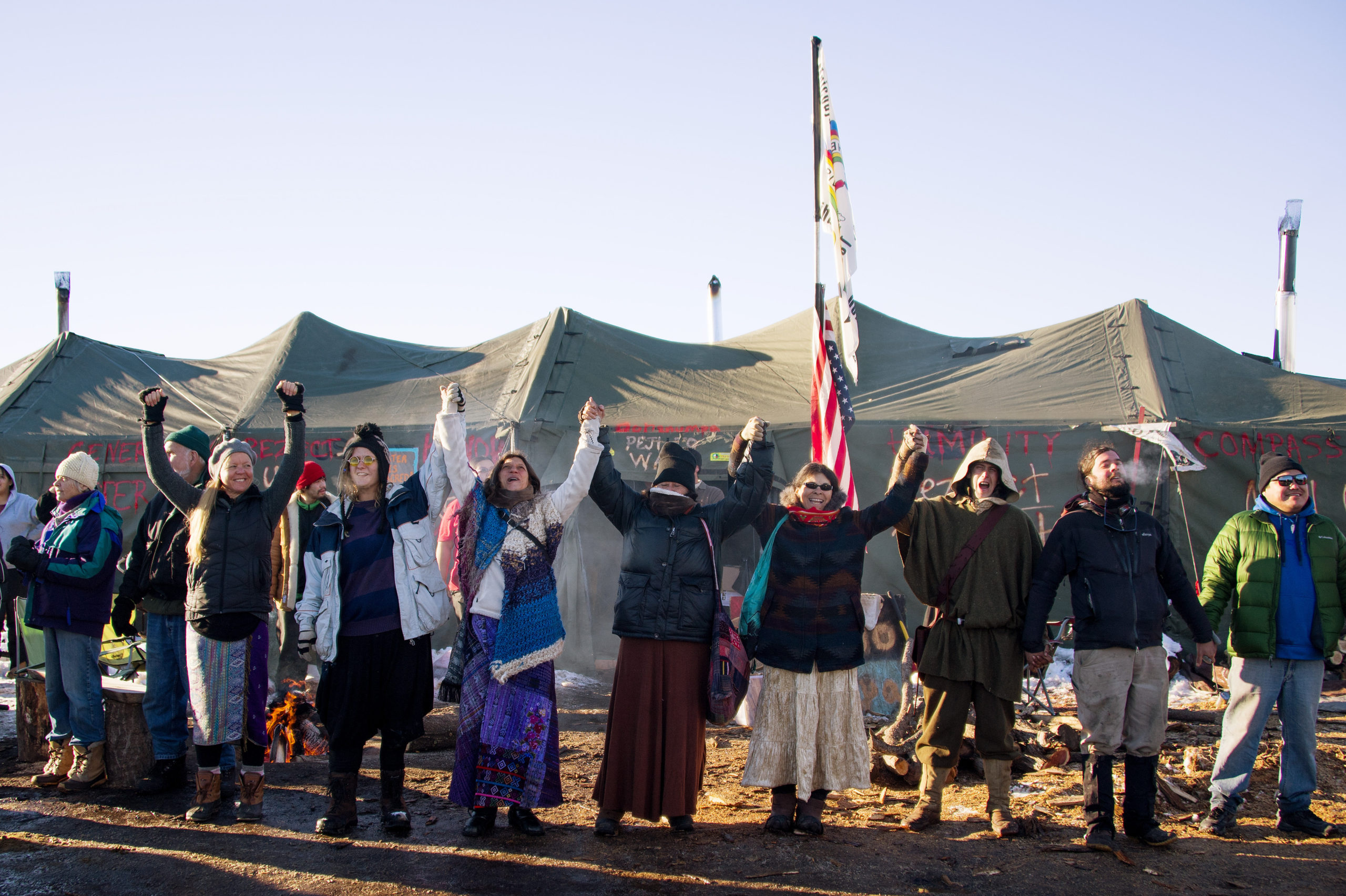Activists celebrate at Oceti Sakowin Camp on the edge of the Standing Rock Sioux Reservation on December 4, 2016 outside Cannon Ball, North Dakota. The Army Corps of Engineers told Standing Rock Sioux Chairman Archambault Sunday that the current route for the Dakota Access pipeline will be denied. / AFP / JIM WATSON (Photo credit should read JIM WATSON/AFP via Getty Images)